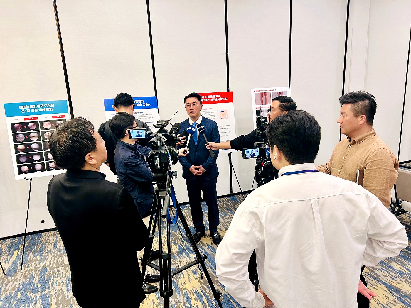 Television crews interviewing a Korean physician at a KoreMed-organized event